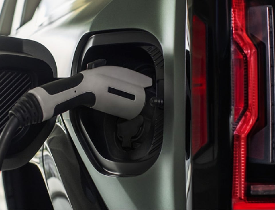 Close up of charging port with charger plugged in on a GMC Hummer EV SUV - Freedom Buick GMC by Ed Morse in DALLAS TX